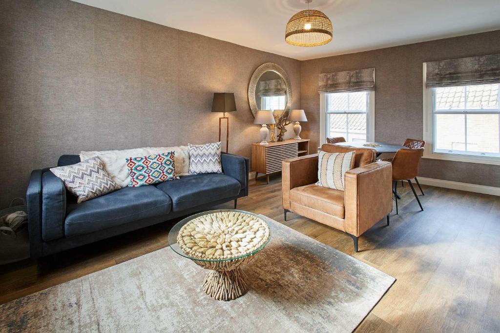 a living room with a couch and a table at Host & Stay - Baxtergate Apartments in Whitby