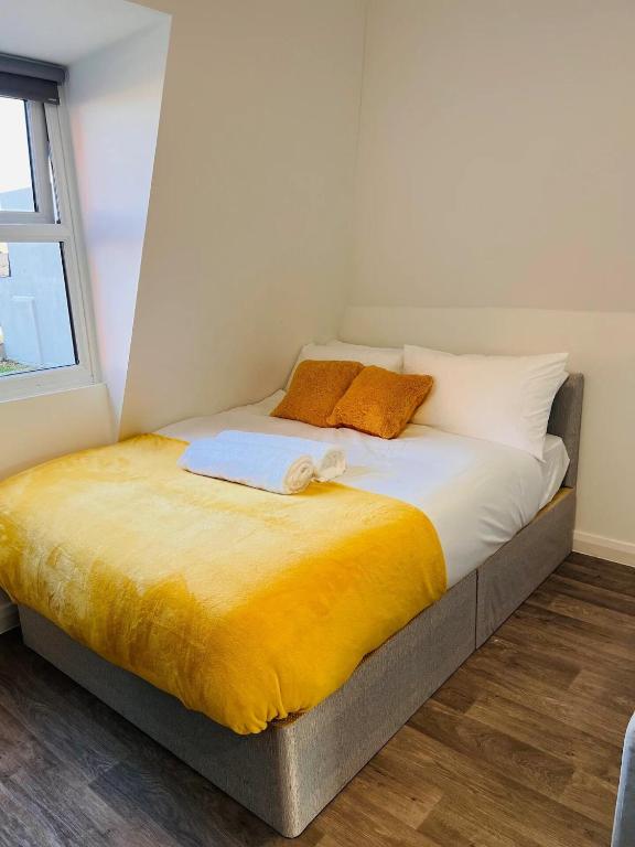 a bed with two pillows on it in a room at Cozy Studio in Maidstone Town Centre in Kent