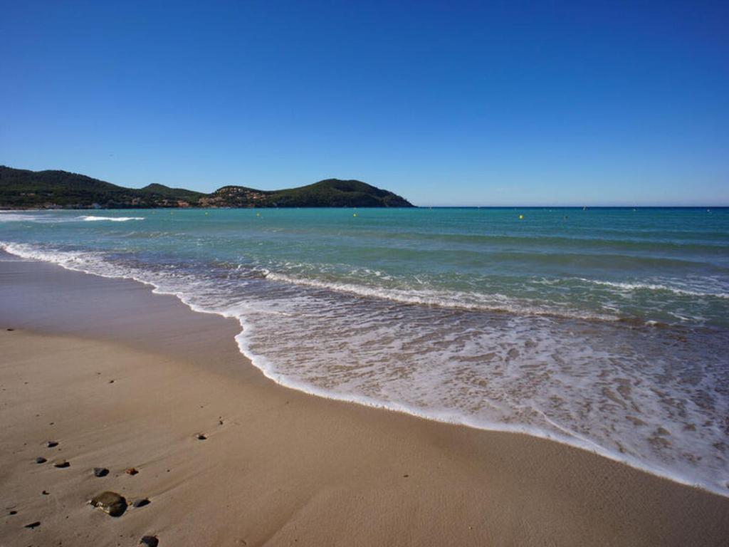 a beach with footprints in the sand and the ocean at T2 rez de villa proche de la mer b&b sita in Saint-Cyr-sur-Mer