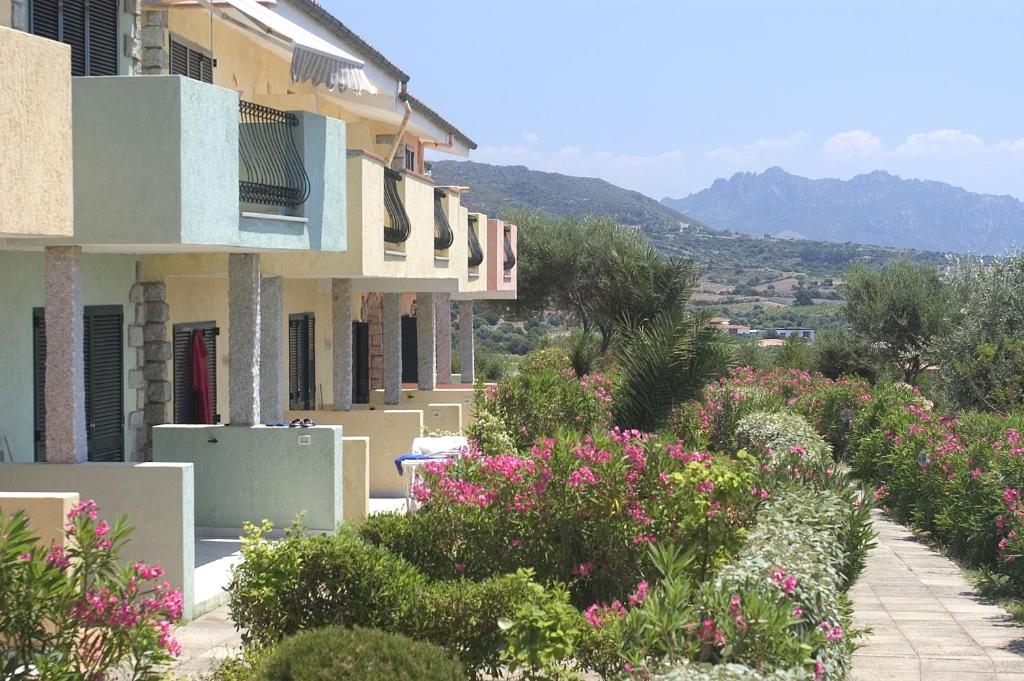a row of houses with flowers in front of them at Borgo del Tennis - Sa Ventana 2 in Badesi