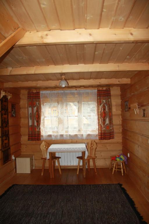 a room with a table and chairs and a window at U Nas Pokoje Goscinne in Zakopane