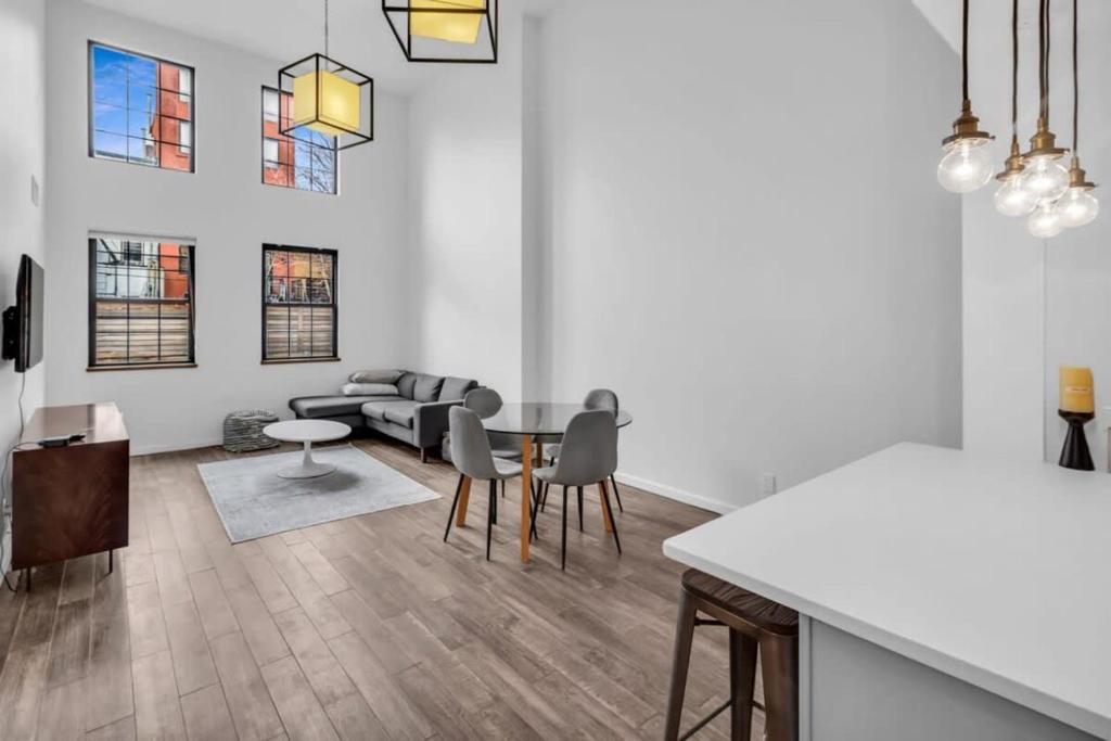a living room with a table and a couch at Stylish 2BR Loft - Carroll Gardens - Prime area in Brooklyn