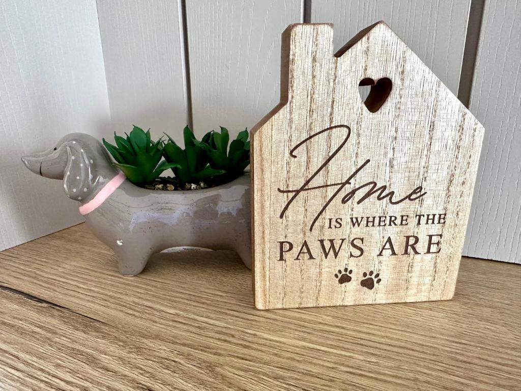 a wooden sign that says vine is where the paws are at Paws Lodge, Hot Tub, Pet Friendly in South Cerney