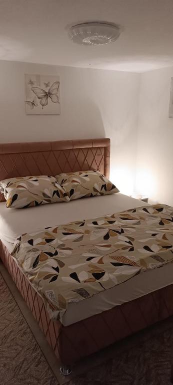 a large bed in a bedroom with a bed frame at Villa SHAMS in Travnik