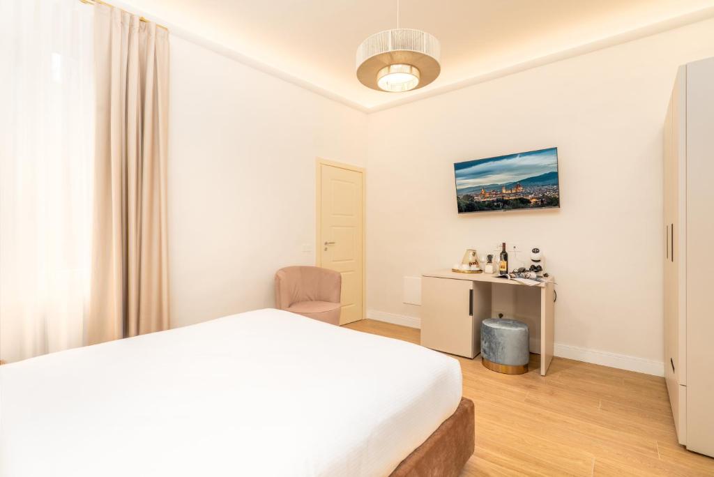 Postel nebo postele na pokoji v ubytování Hotel Ginori Al Duomo
