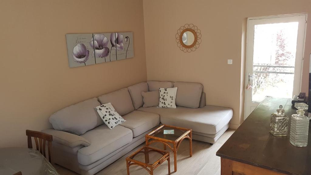 a living room with a couch and a table at Gîte Valentine in Aubin