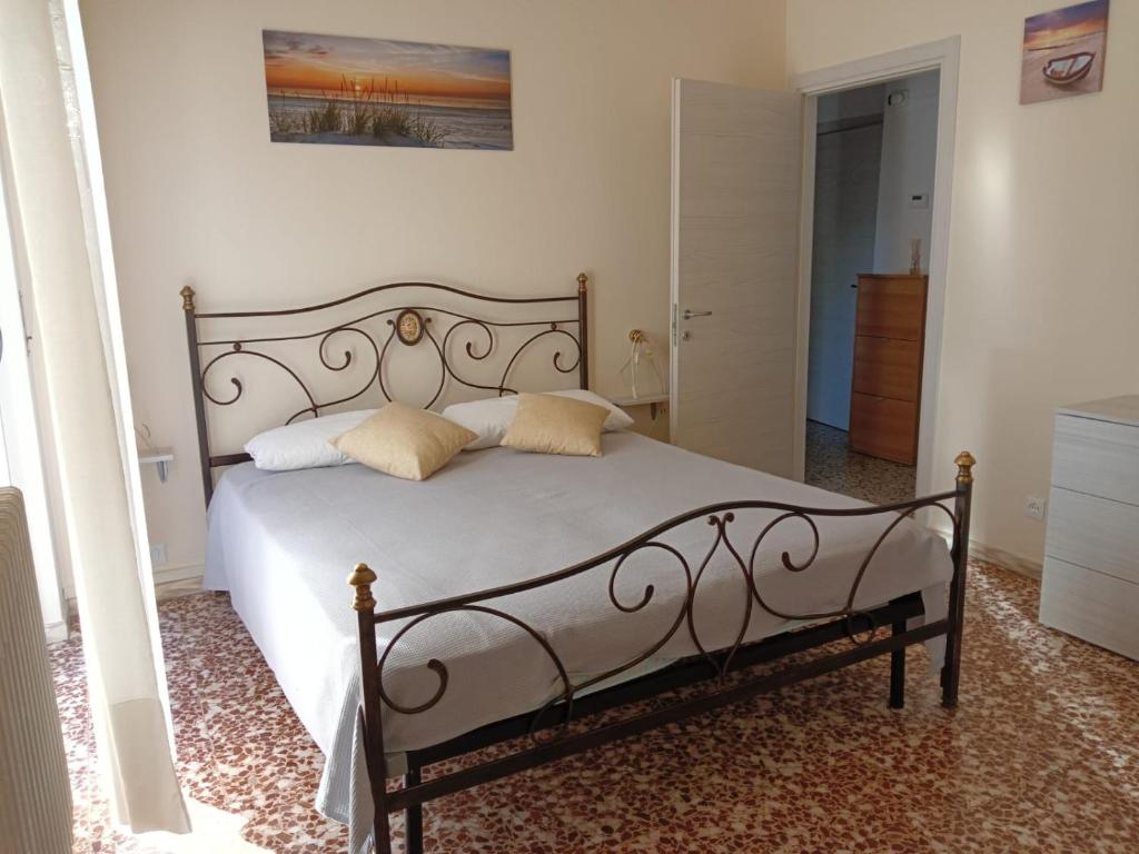a bedroom with a white bed with pillows on it at Casa Margherita - bike friendly in Verbania