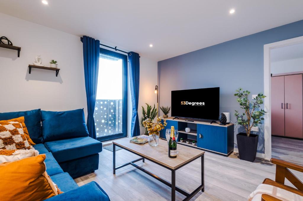 a living room with a blue couch and a tv at NEW! Pristine 2-Bed Flat on Liverpool by 53 Degrees Property, Amazing Location, Sleeps 6! in Liverpool