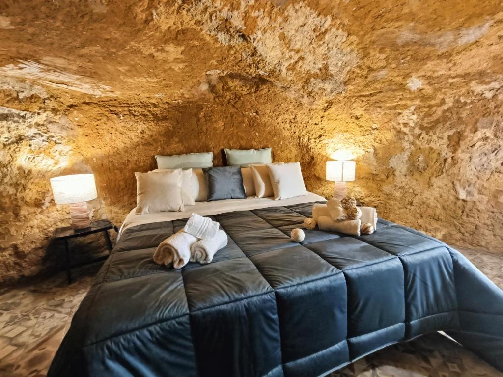 a bedroom with a large bed in a cave at Historic Center Apartment in Agrigento
