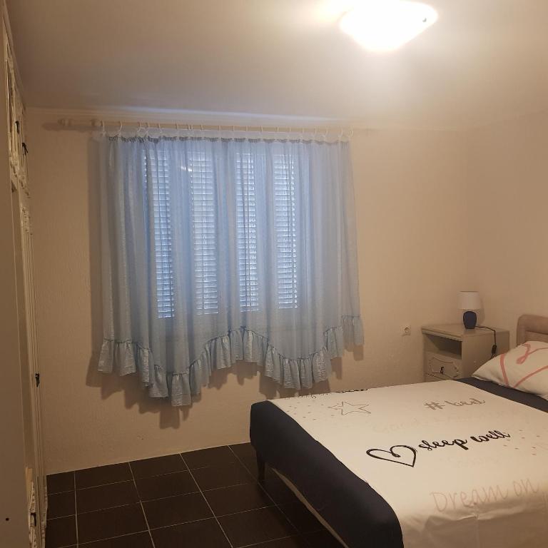 Postel nebo postele na pokoji v ubytování Apartments Nenadić