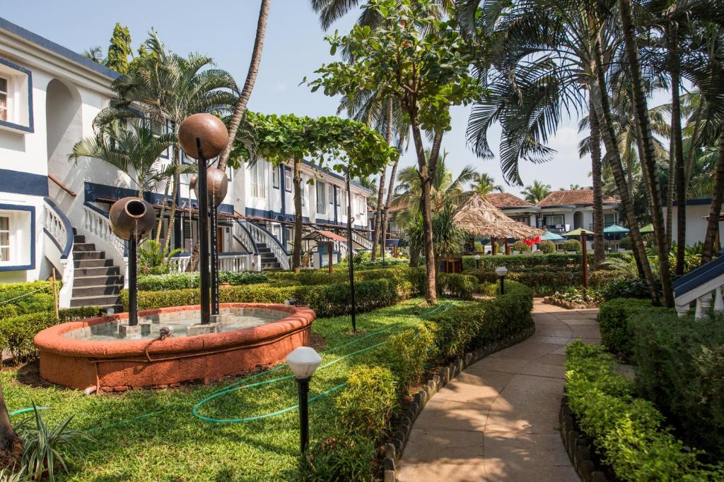 un jardín con una fuente en medio de un edificio en 2 Bedroom Apartment in Resort on Candolim Beach en Baga