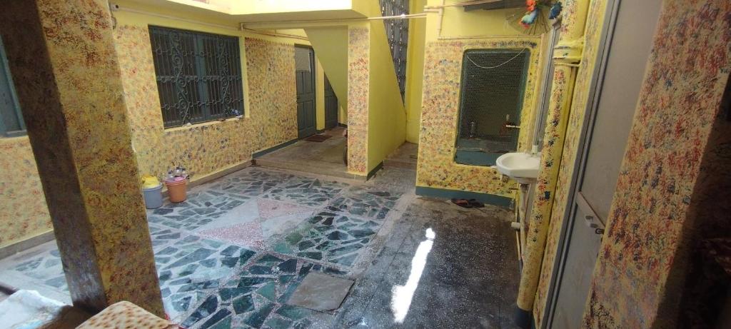 a bathroom being remodeled with a stone floor and walls at Sri Viswanatham Guest House in Varanasi
