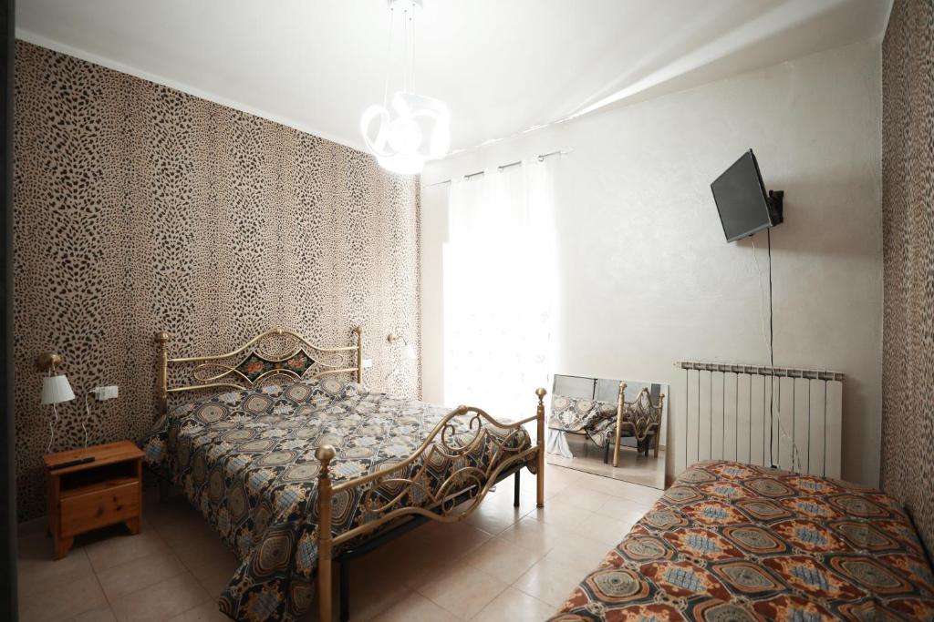 a bedroom with a bed and a tv and a window at La Casa di Chiara in Coazzano