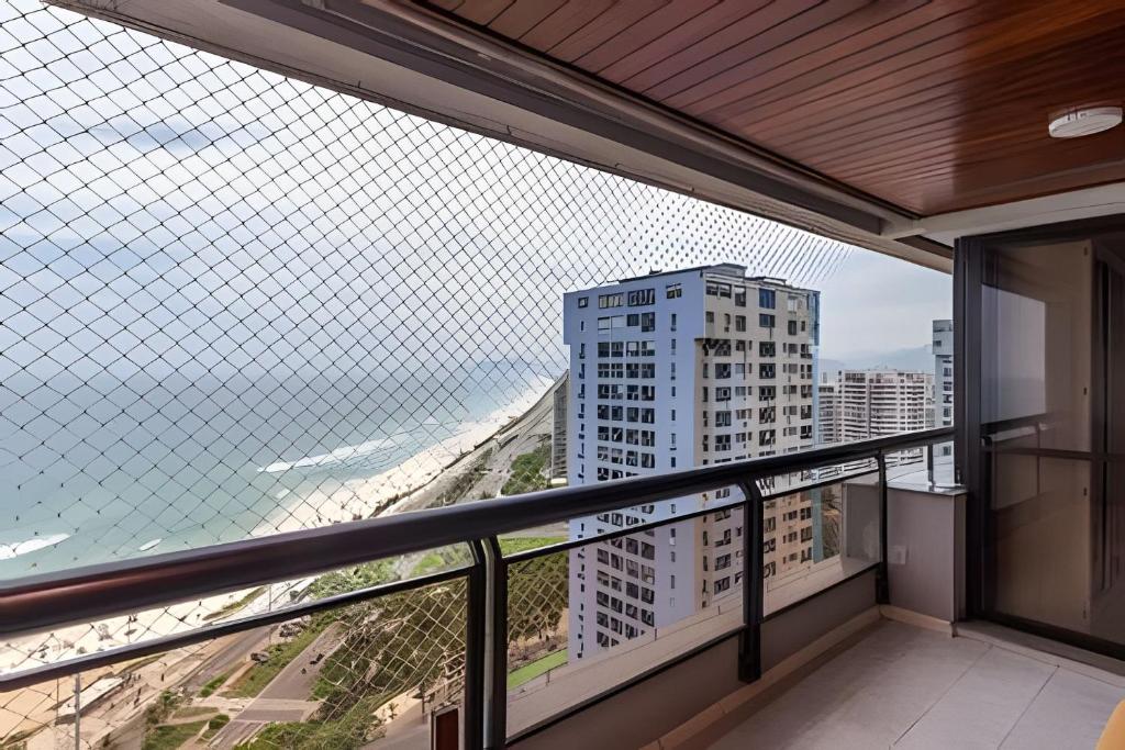 a balcony with a view of a building at Vista Panoramica da Praia com 2qts, e vaga in Rio de Janeiro