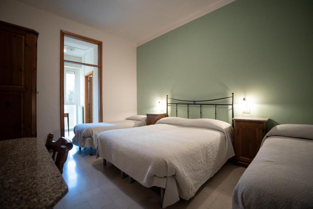 Postel nebo postele na pokoji v ubytování Hotel Leon D'Oro
