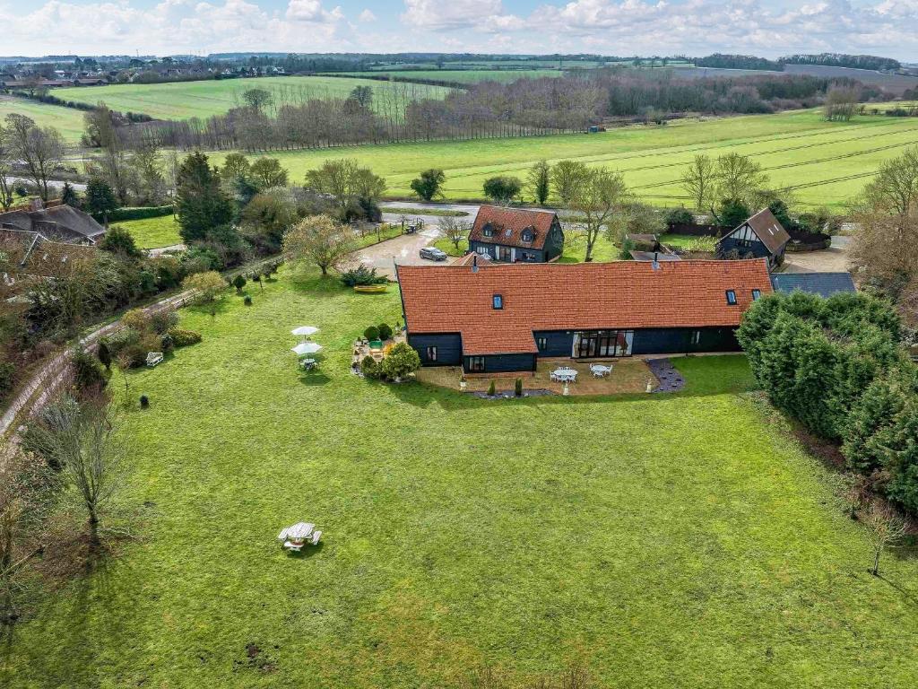 an aerial view of a house with sheep in a field at Doves Barn in Needham Market