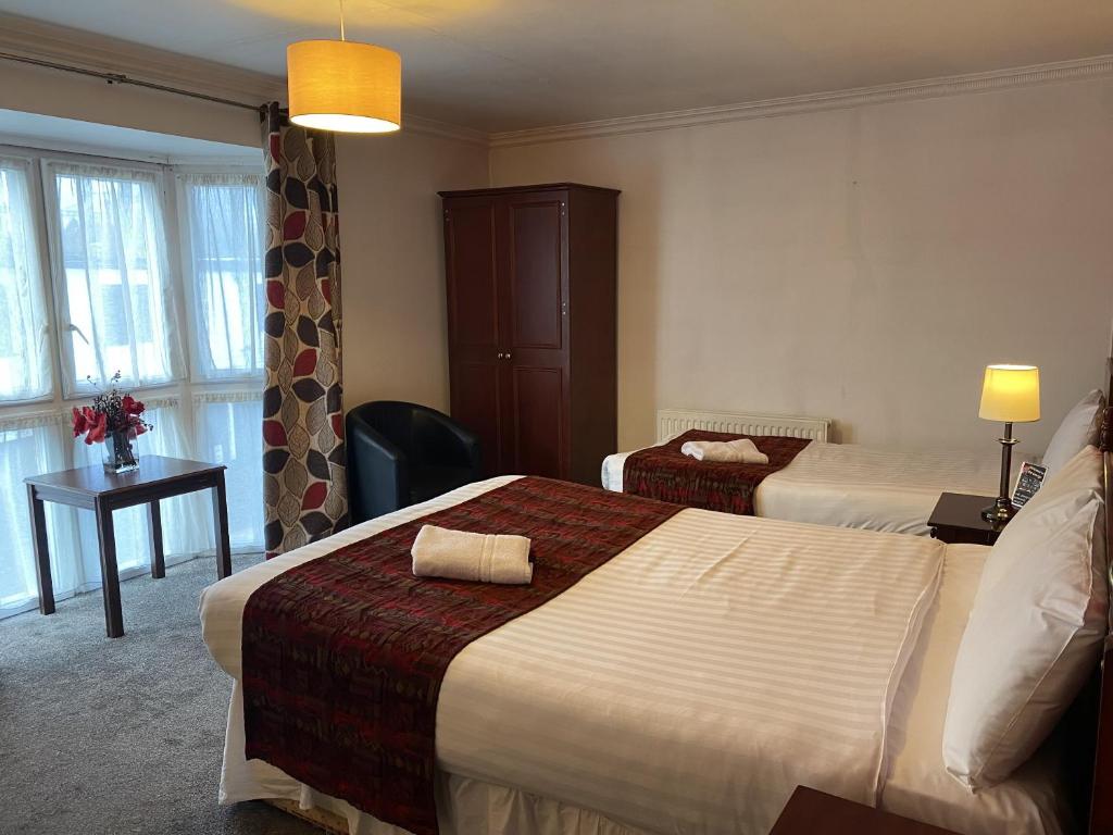Postel nebo postele na pokoji v ubytování The George Hotel Pangbourne