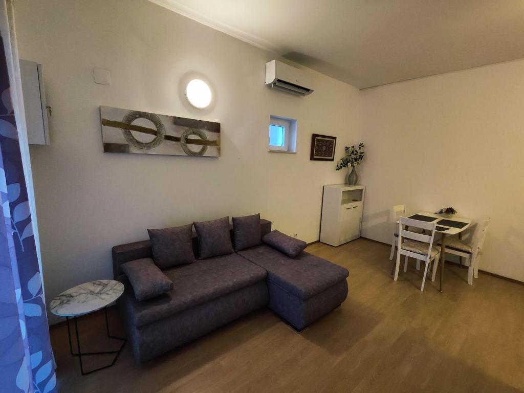 a living room with a couch and a table at Appartment Ksenija 3 in Mali Lošinj