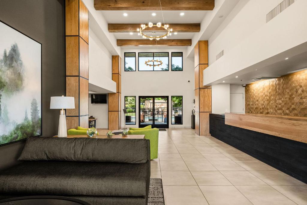 a living room with a couch and a table at Oxford Suites Redding in Redding