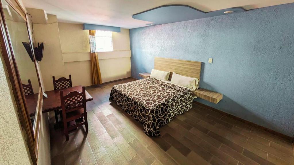 Кровать или кровати в номере Hotel Plaza San Juan
