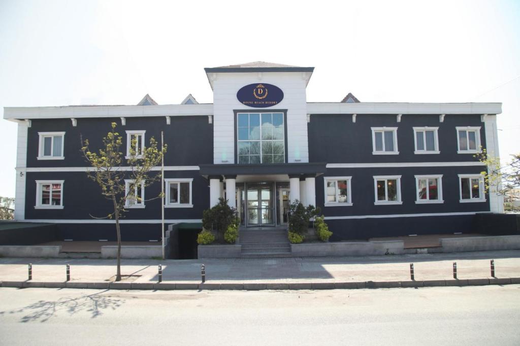 a large black building with a sign on it at Divine Beach Resort Kumburgaz in Buyukcekmece