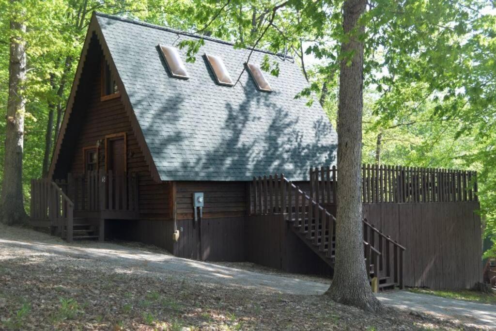 a log cabin with a gambrel roof and a staircase at A-Frame Cabin #5 with Hot Tub on Patoka Lake in Southern Indiana in Paoli