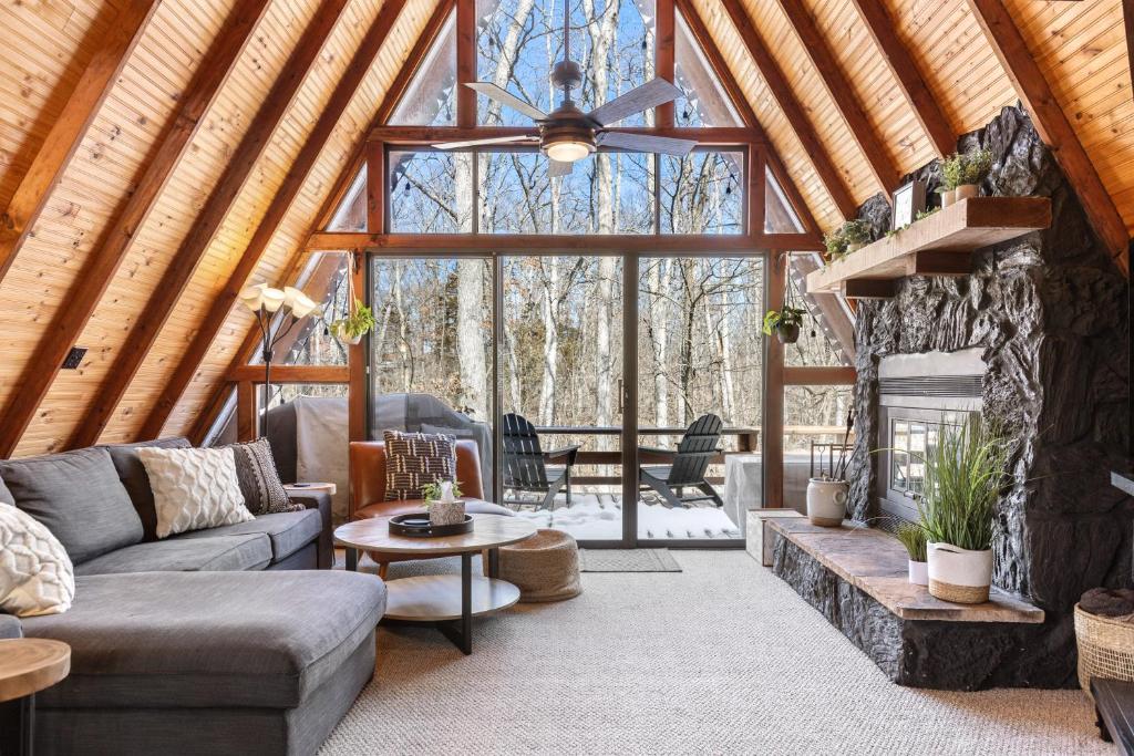 a living room with a couch and a large window at 614 Aspen Woods Chalet in Innsbrook