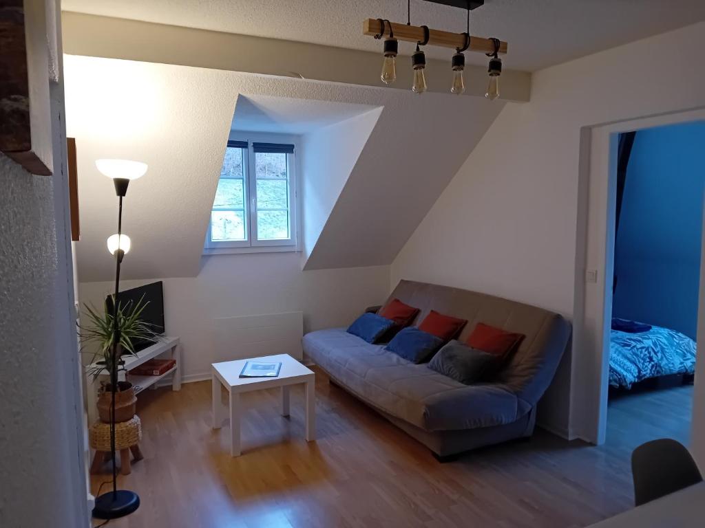 a living room with a couch and a table at Appartement vallée de Campan in Campan
