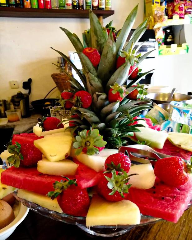 a plate of cheese and fruit on a table at CASA DA HORTA in Aljezur