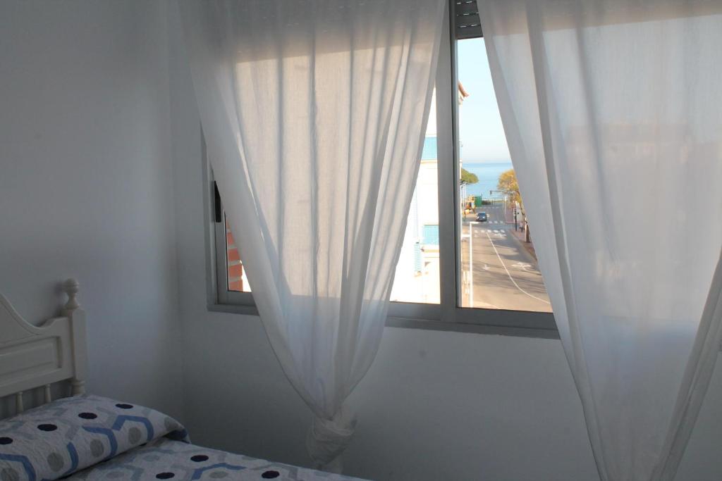 A bed or beds in a room at ApartiaBeach Apartamentos