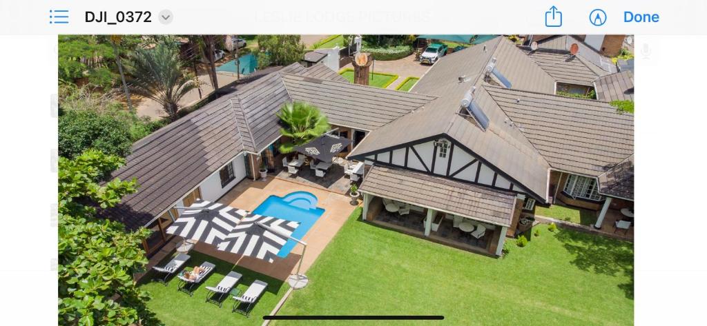 an aerial view of a house with a swimming pool at The Leslie - Bed & Breakfast in Blantyre