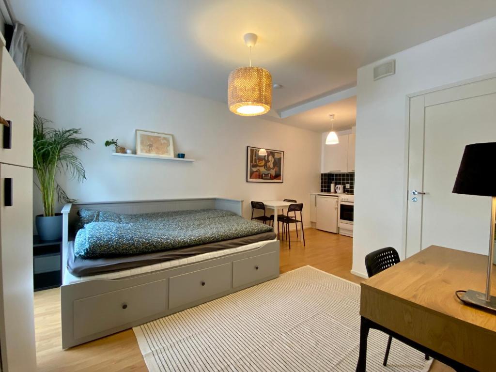 a bedroom with a bed and a dining room at Tranquil studio near nature, free parking& wifi in Helsinki