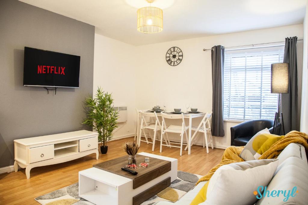 a living room with a couch and a table at Liverpool City Flat 4 by Sheryl - Close to City Center, Anfield Stadium and Airport with free business super fast fibre broadband in Liverpool