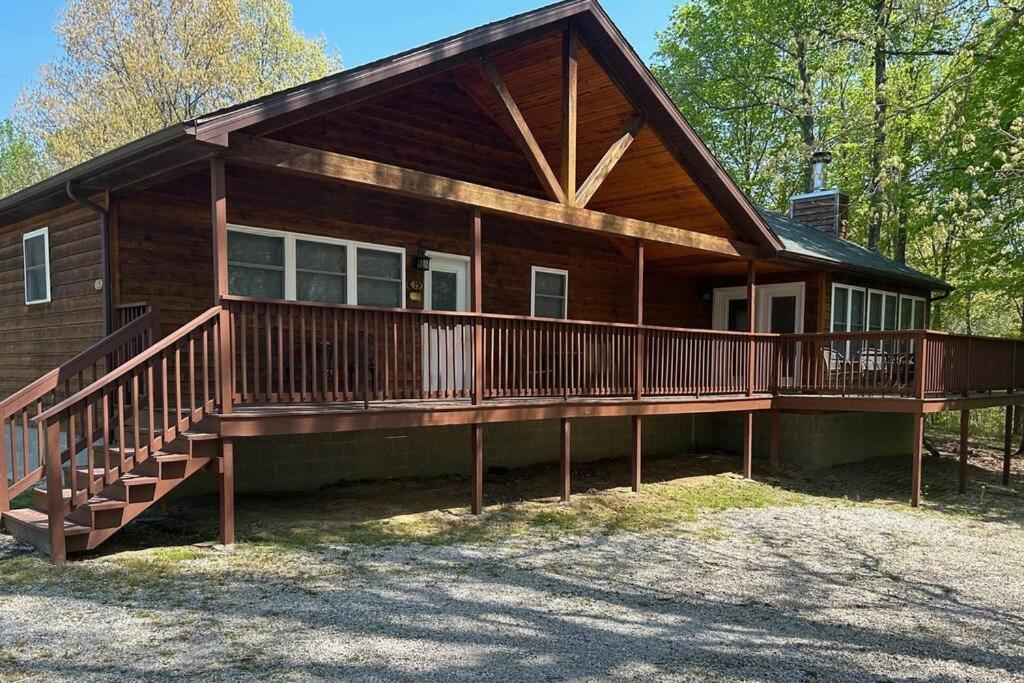 a large wooden house with a large deck at Solarium Deluxe Cabin #19 on Patoka Lake in Southern Indiana in Seymour
