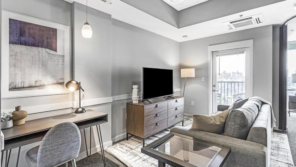 ein Wohnzimmer mit einem Sofa und einem TV in der Unterkunft Landing Modern Apartment with Amazing Amenities ID1805X70 in Indianapolis
