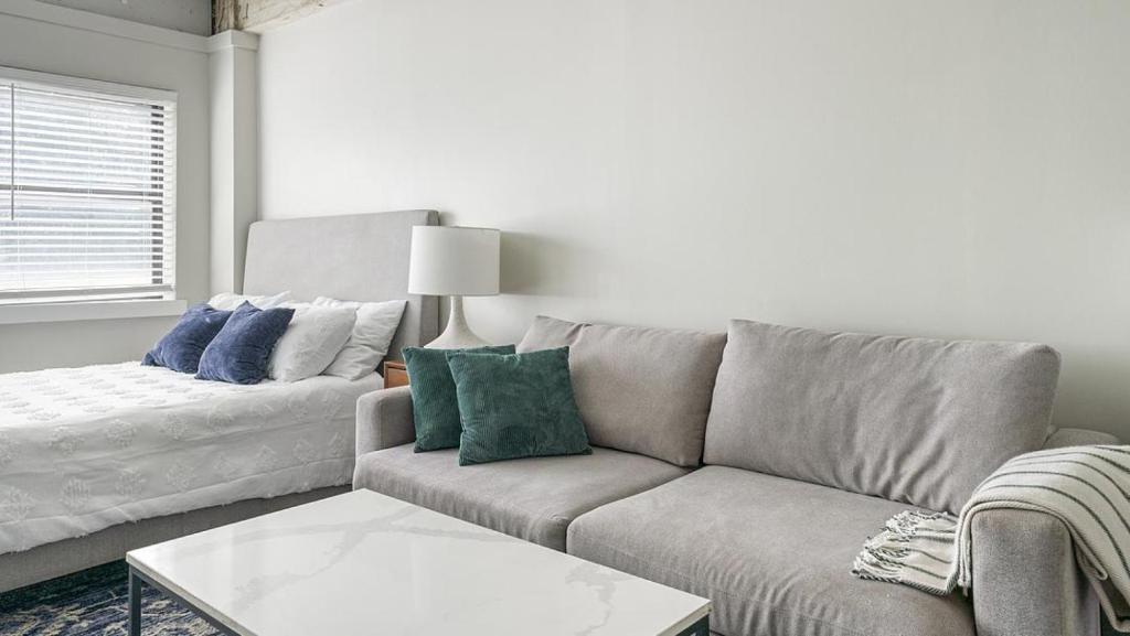 a living room with a couch and a table at Landing Modern Apartment with Amazing Amenities (ID1803X66) in Mobile