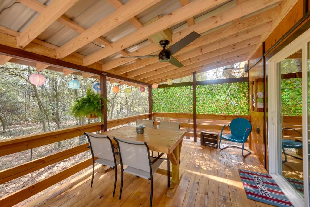 a dining room with a table and chairs at Bright Cabin with Fire Pit - 2 Mi to Holden Beach! in Supply