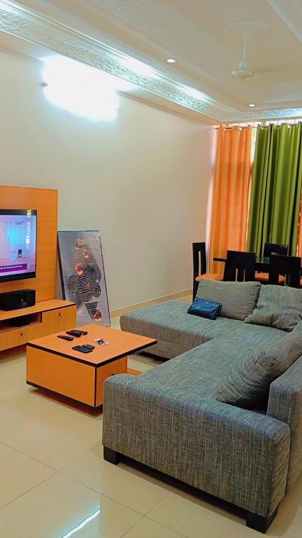 a living room with a couch and a tv at Timba Miché04 in Cotonou