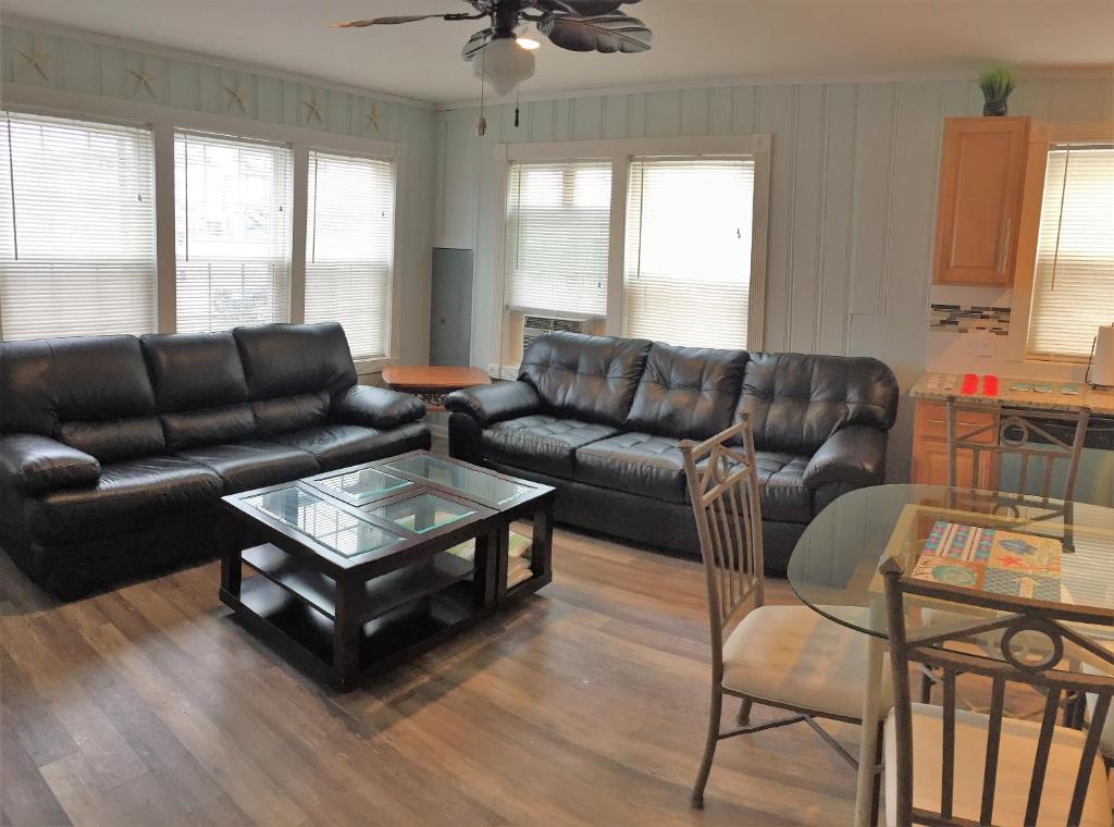 a living room with black leather furniture and a table at 6B Best Location, 4 bedrm, 2 bathrm Beach Block in Seaside Heights