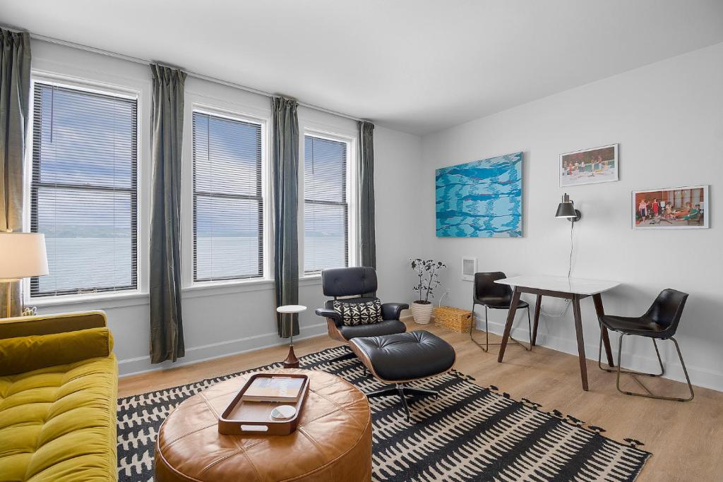 a living room with a couch and chairs and a table at Norblad Hotel in Astoria, Oregon