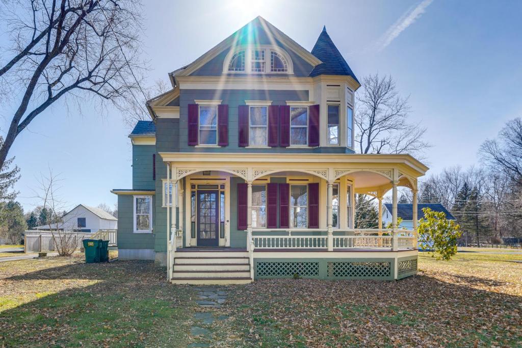 a blue house with a porch on a yard at Pet-Friendly Hudson Home Near Won Dharma Center! in Hudson