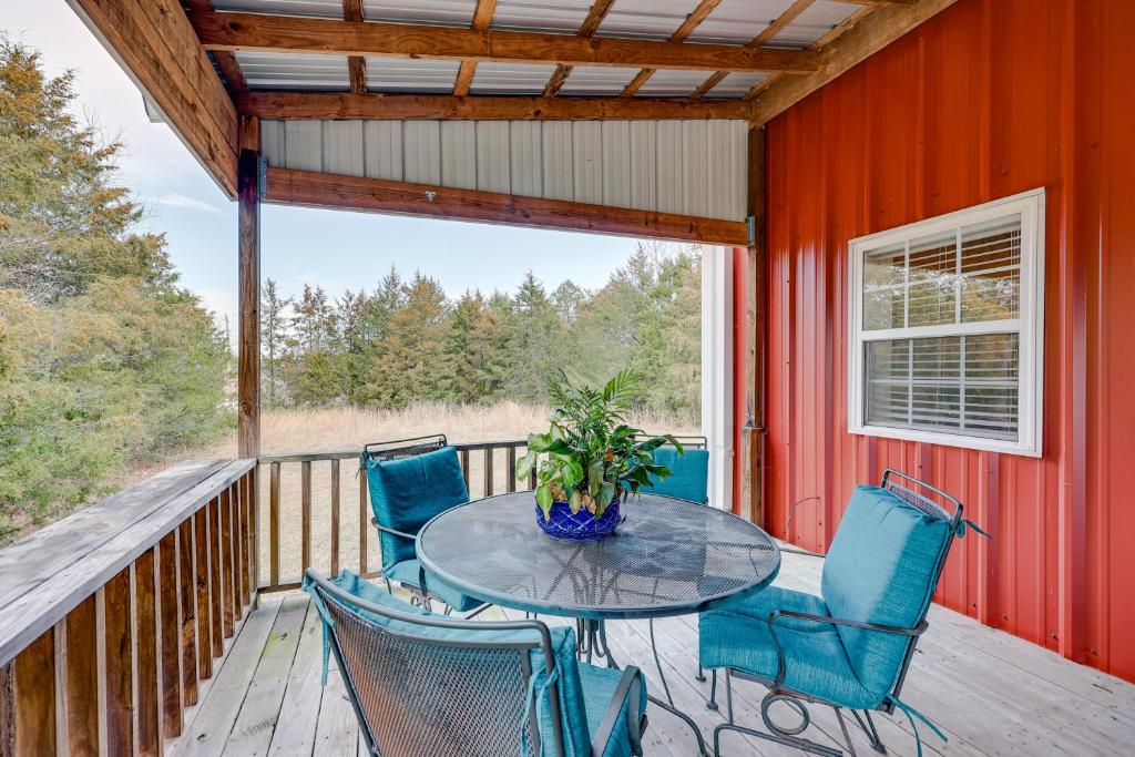 a patio with a table and chairs on a deck at Pet-Friendly Dover Cottage w/ Deck + Mtn Views! in Dover
