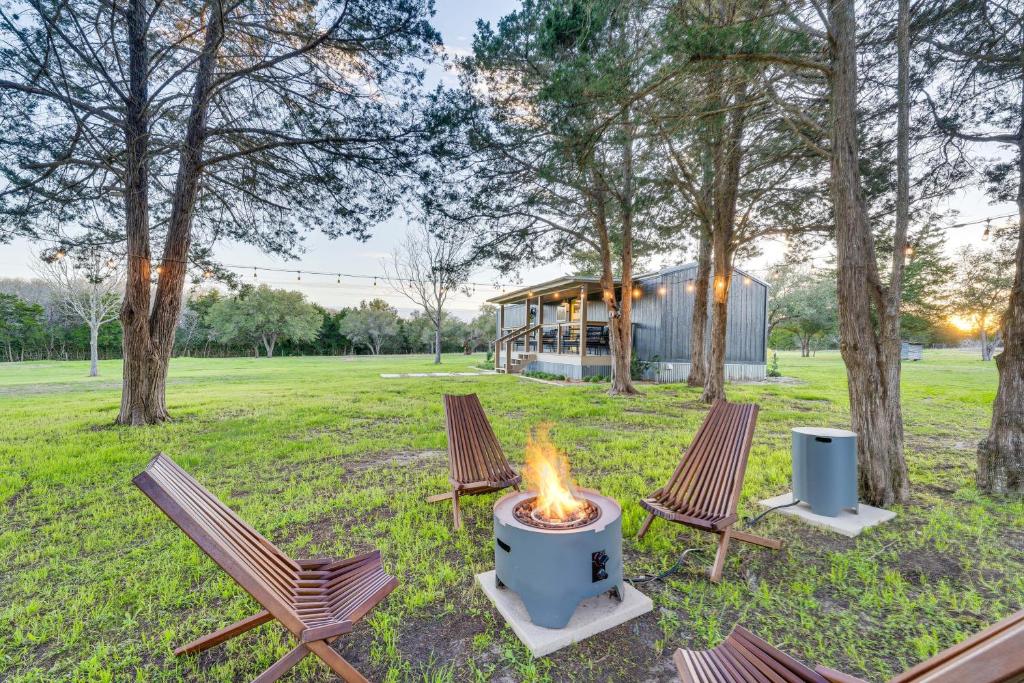 a fire pit in a yard with chairs and trees at Private Schulenburg Cabin Near Winery! in Schulenburg
