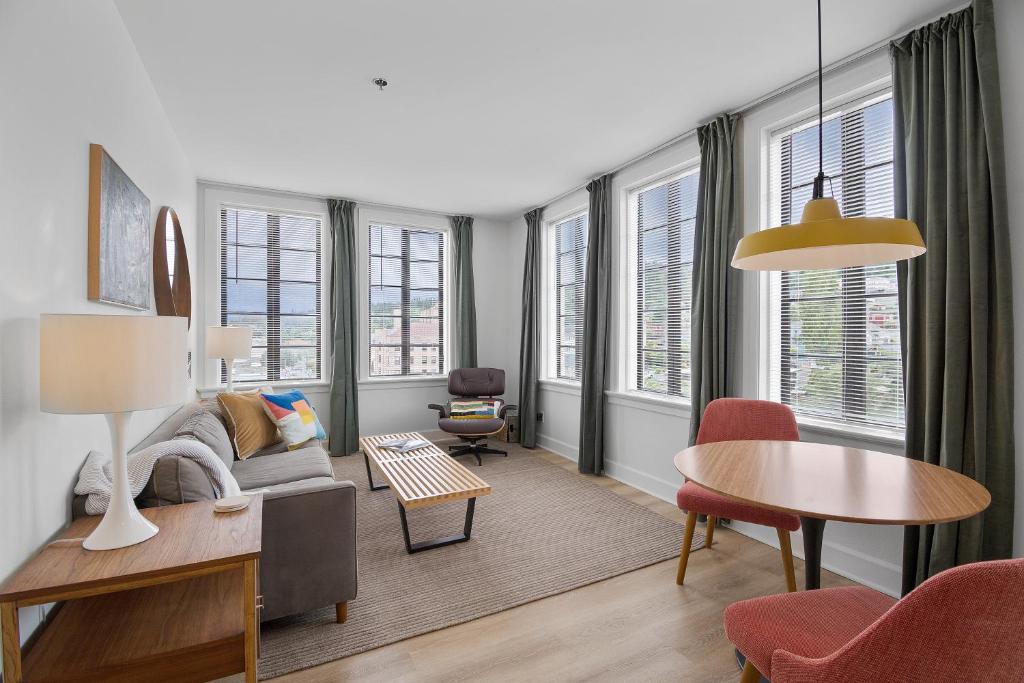 a living room with a couch and a table at Norblad Hotel in Astoria, Oregon