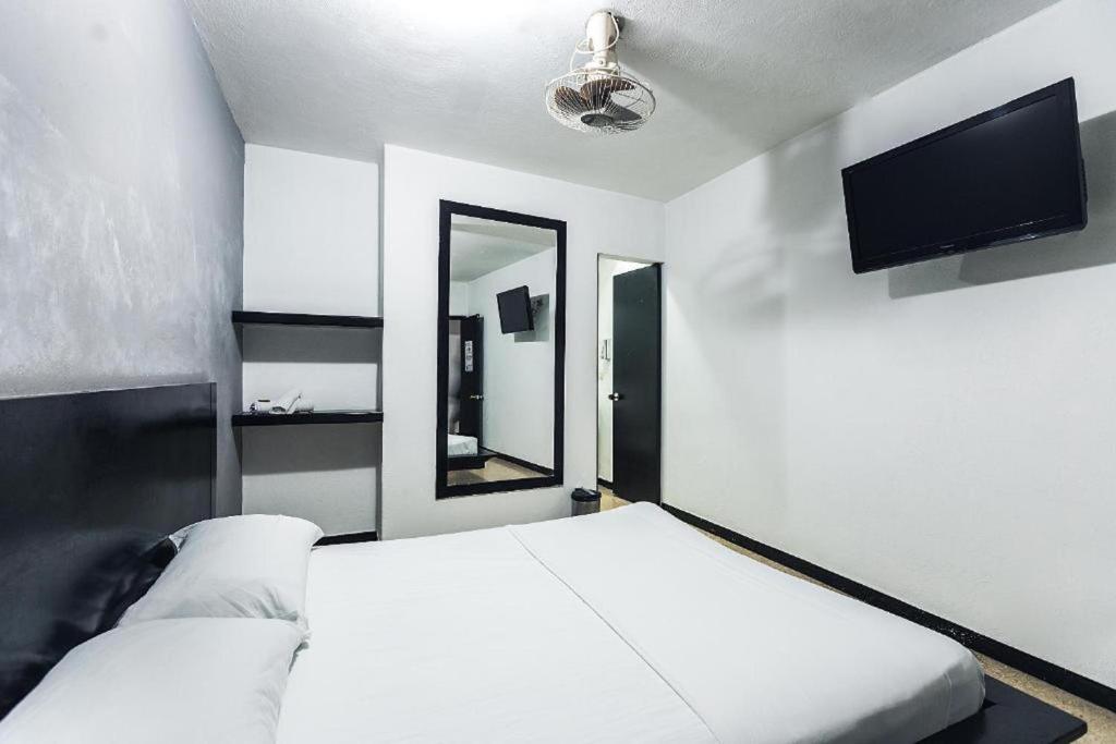 Postel nebo postele na pokoji v ubytování Green Hotel Natural Medellin