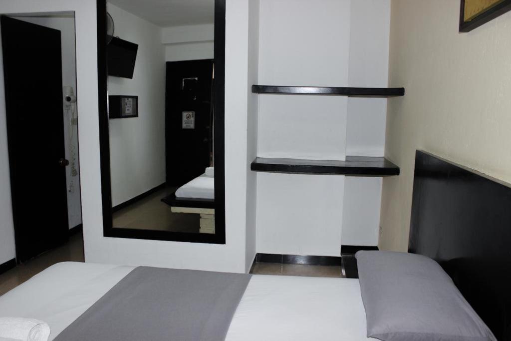 Postel nebo postele na pokoji v ubytování Green Hotel Natural Medellin