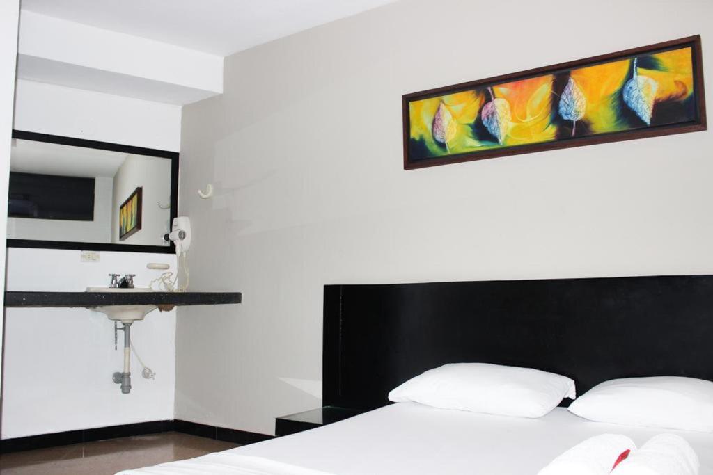 Postel nebo postele na pokoji v ubytování Green Hotel Natural Medellin