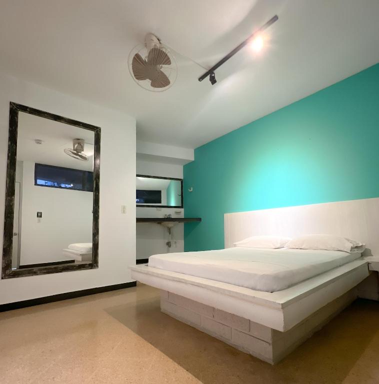 Postel nebo postele na pokoji v ubytování Green Hotel Natural Medellin