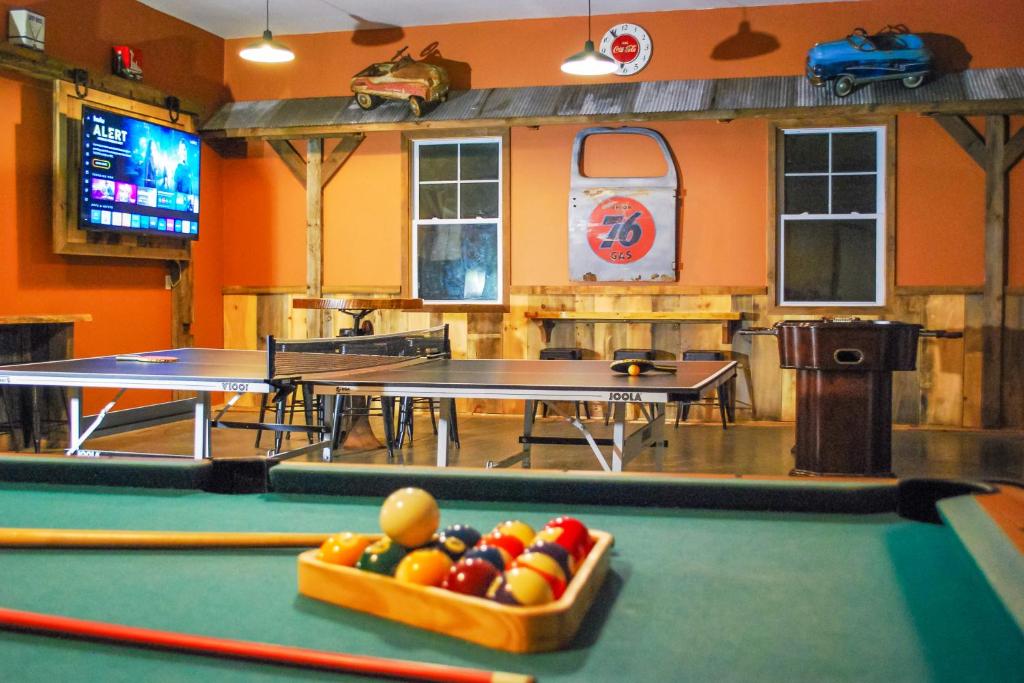 a billiard room with two tables and a bowl of balls at Lakefront Wisconsin Dells Home with Game Room in Wisconsin Dells
