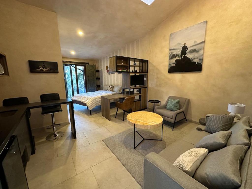 a living room with a couch and a bed at Loft Loreto en Val'Quirico in Santeagueda
